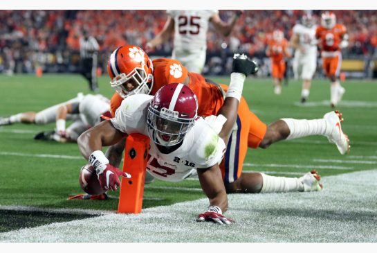 Alabama's Kenyan Drake dives to the pylon to complete a 95-yard kick return in the Crimson Tide's 45-40 win over previously undefeated Clemson in the U.S. college football title game