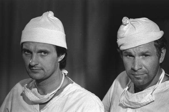 American actors Alan Alda and Wayne Rogers appear in character as surgeons Captain Benjamin Franklin'Hawkeye Pierce and Captain'Trapper John Mc Intyre on set for the episode'German Warfare of the CBS Korean War comedy'MASH' California July