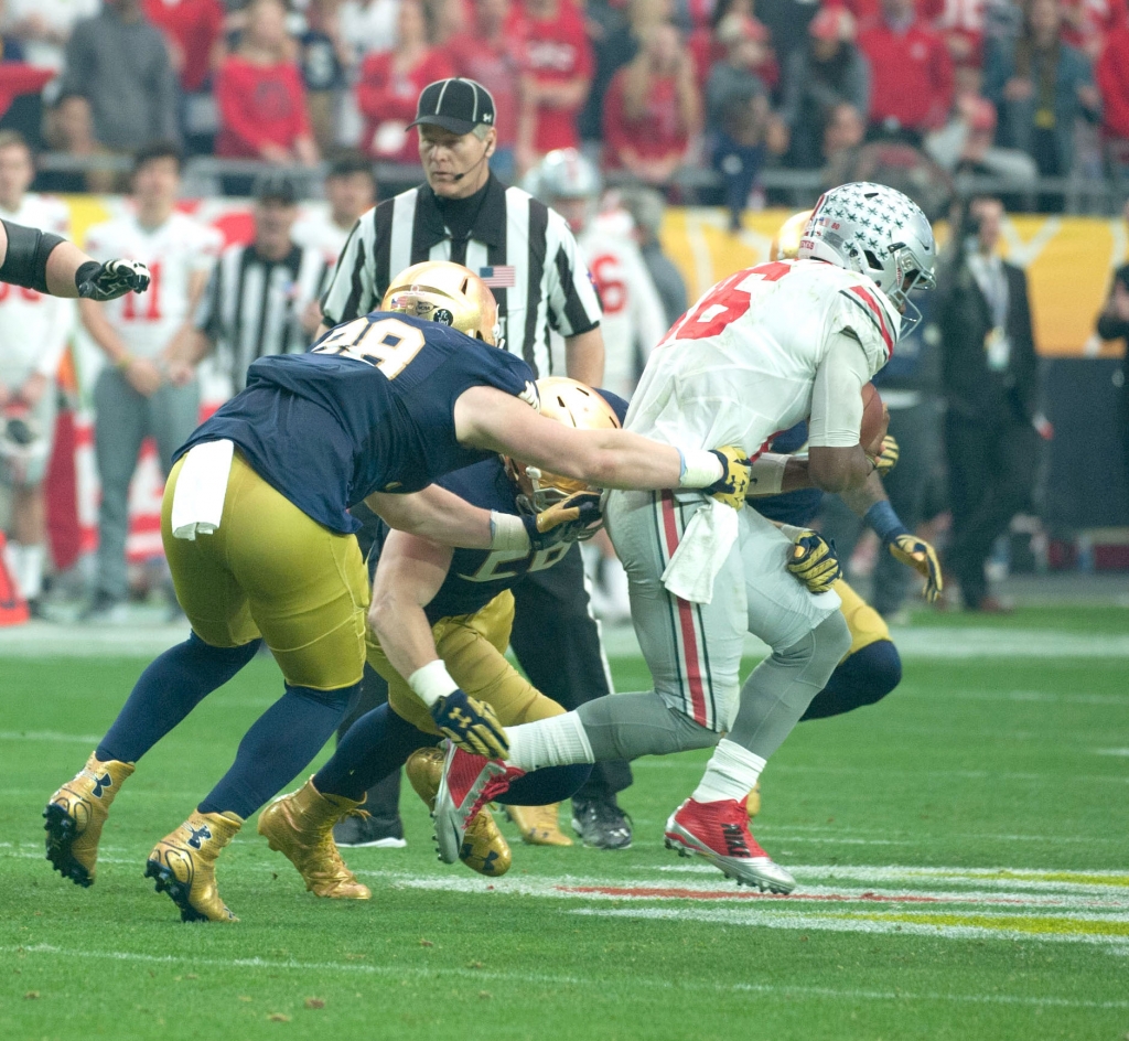 Irish sophomore defensive lineman Andrew Trumbetti tackles Ohio State sophomore quarterback J.T. Barrett during Notre Dame's 44-28 loss to the Buckeyes on Friday in the Fiesta Bowl in Glendale Arizona