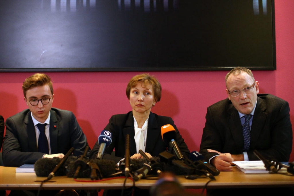 Marina Litvinenko and her son Anatoly listen as their lawyer Ben Emmerson speaks during a press conference after receiving the results of the inquiry into the death of Marina's husband Alexander Litvinenko