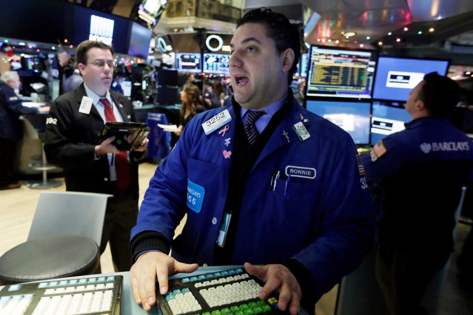 Specialist Ronnie Howard center works on the floor of the New York Stock Exchange Tuesday Jan. 5 2016. U.S. stocks are opening modestly higher as trading stabilizes a day after a plunge in China unsettled investors around the globe