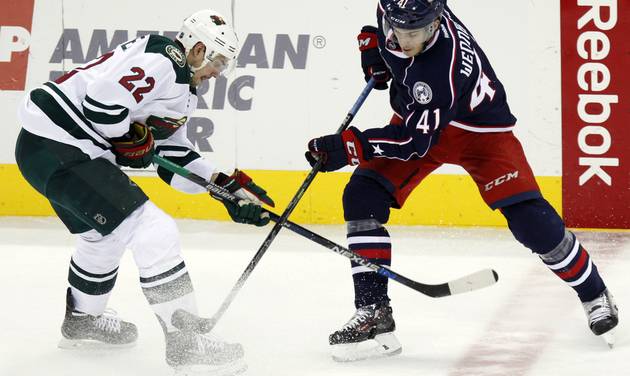 Minnesota Wild's Nino Niederreiter left of Switzerland works for the puck against Columbus Blue Jackets&#039 Alexander Wennberg of Sweden during the third period of an NHL hockey game in Columbus Ohio Tuesday Jan. 5 2016. Minnesota won 4-2