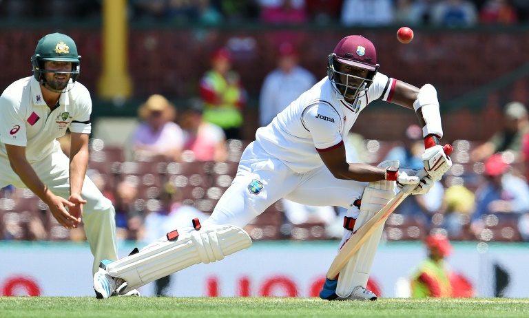 AFP  William West West Indies batsman Kemar Roach drives a ball from the Australian bowling as fieldsman Joe Burns look on on the final day of the third Test in Sydney