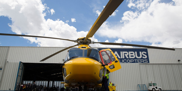 Workers make a final check on an Airbus helicopter before a demonstration flight in Mexico City