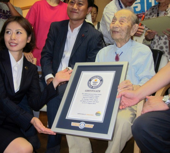 Jiji Press  AFP  File -Yasutaro Koide 112 receives a framed certificate from the Guinness World Records as the world's oldest man in Nagoya central Japan's Aichi prefecture in August 2015