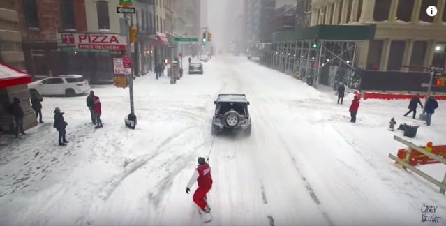 Filmmaker Casey Neistat snowboards through NYC streets during blizzard