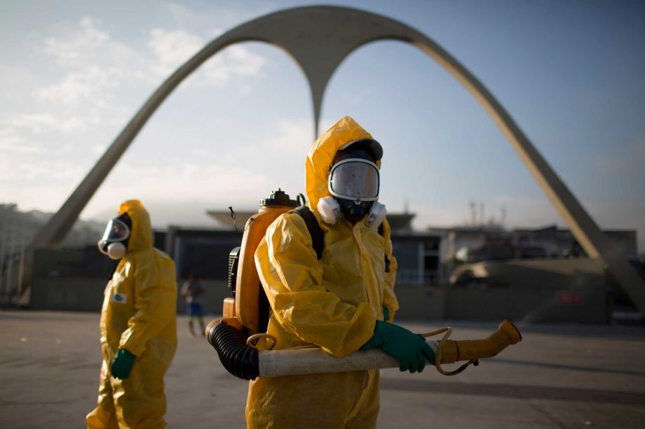 A health worker stands in the Sambadrome as he sprays insecticide to combat the Aedes aegypti mosquitoes that transmits the Zika virus in Rio de Janeiro Brazil Tuesday Jan. 26 2016. Inspectors begin to spray insecticide around Sambadrome the outdoor