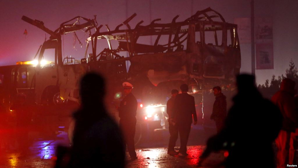 Afghan policemen and firefighters inspect the wreckage of a bus that was hit by a suicide bomb attack in an area near the Russian embassy in Kabul Afghanistan Jan. 20 2016