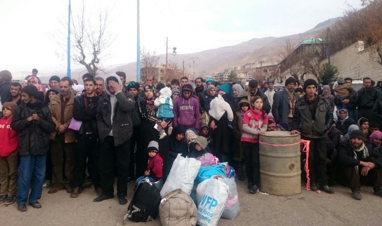 AFP  File -Residents of the besieged Syrian town of Madaya wait for the arrival of an aid convoy