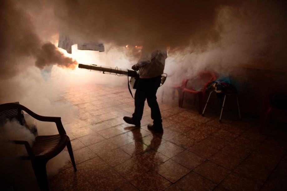 A Health Ministry employee fumigates a home against the Aedes ﻿mosquito ﻿Thursday in Soyapango ﻿El Salvador. The nation of 6 million people has had at least 5,000 cases of the Zika virus