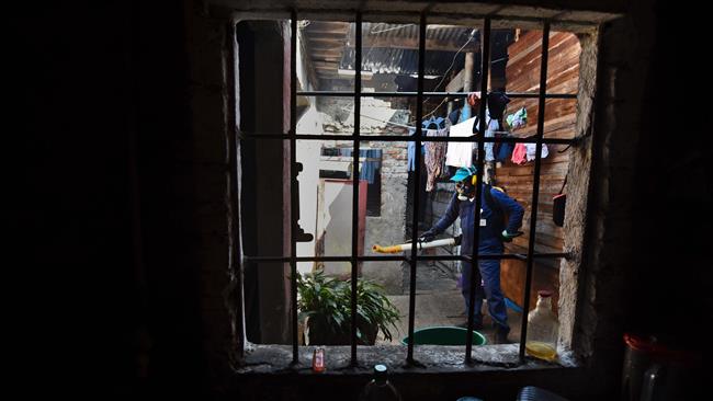 A Health Secretary employee fumigates against Aedes Aegypti mosquitos inside a house in Cali Colombia