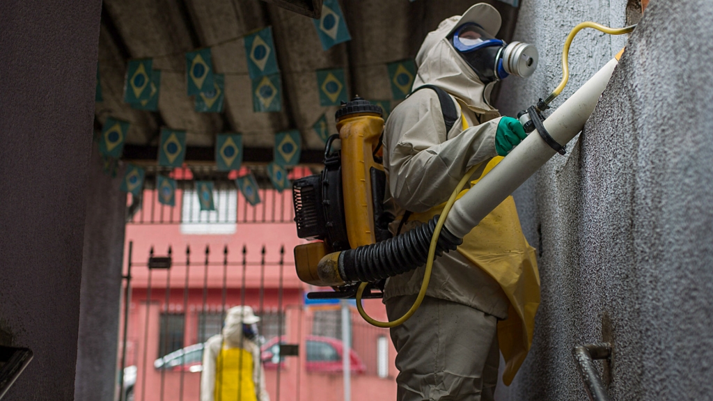 A Rio municipal worker sprays insecticide