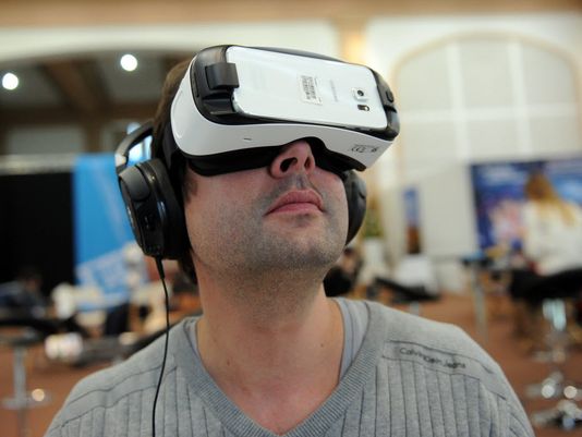 A man tries the virtual reality headset Gear VR for Galaxy by Oculus