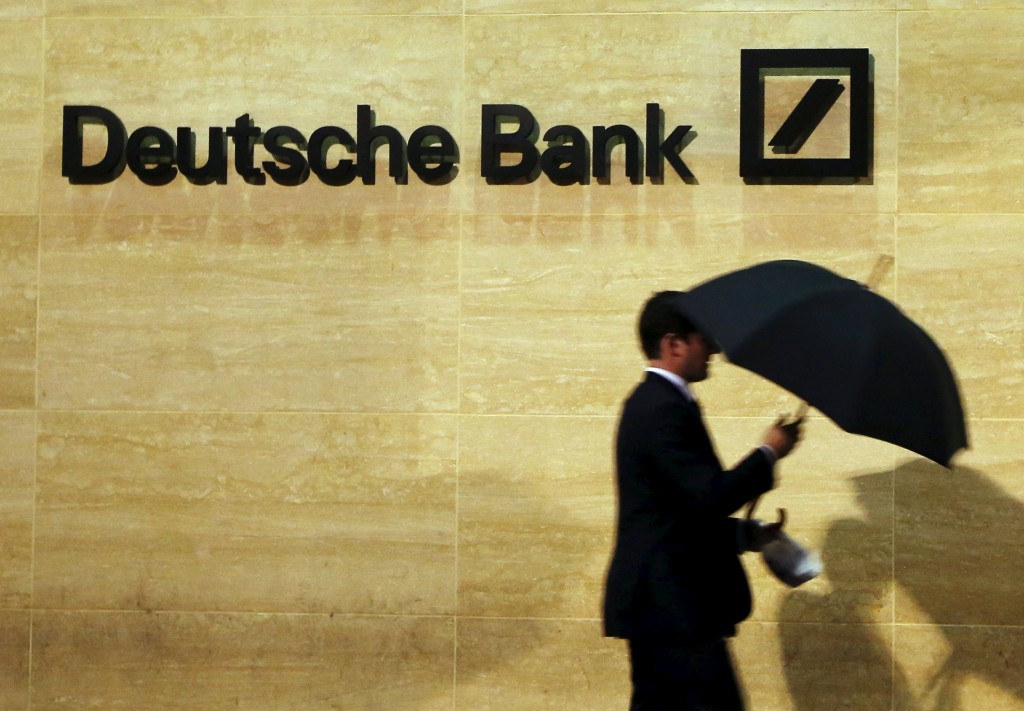 A man walks past Deutsche Bank offices in London in this