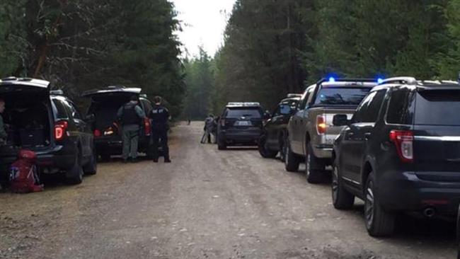 Mason County Wash. Sheriff's Office shows squad cars lined up near the scene of a standoff Friday morning