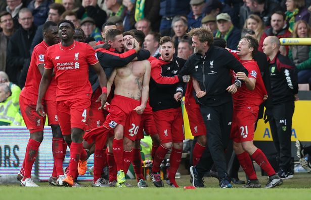 Adam Lallana celebrates with team mates and Jurgen Klopp after scoring the fifth goal for Liverpool