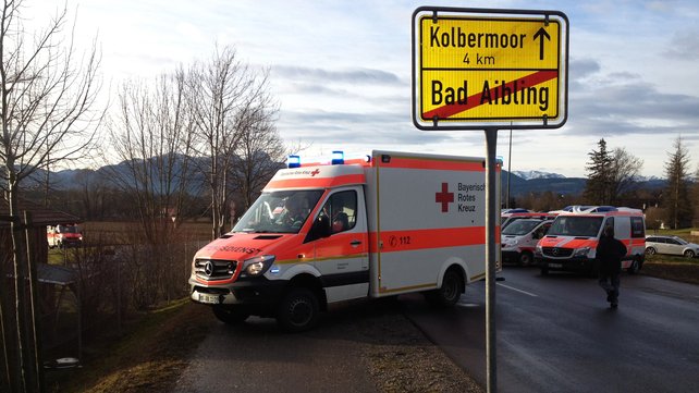 An ambulance next to an exit sign for Bad Aibling Bavaria
