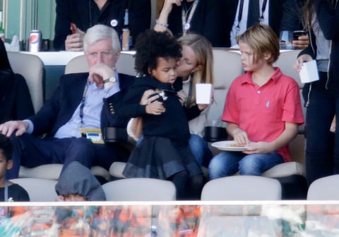 Gwyneth Paltrow holds Jay-Z and Beyonce's daughter Blue Ivy Carter as she attends the 2016 Super Bowl with her children Apple and Moses Martin in Santa Clara California