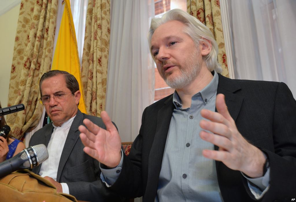 FILE- Ecuador's Foreign Minister Ricardo Patino and Wiki Leaks founder Julian Assange speak during a press conference inside the Ecuadorian Embassy in London where he confirmed he'will be leaving the embassy soon, Monday Aug. 18 2014