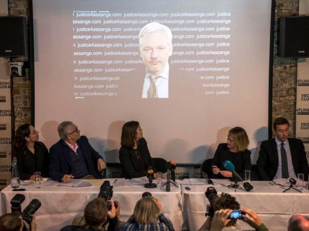 WikiLeaks founder Julian Assange is projected onto a screen behind Spanish jurist Baltasar Garzon and Australian lawyers Melinda Taylor and Jennifer Robinson as he speaks via video-link from the Ecuadorean embassy at a press conference