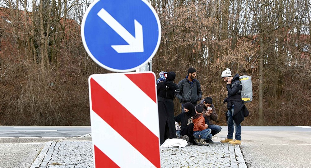 Migrants make a break in Erding downtown after their visit to the first registration camp of Erding near Munich Germany