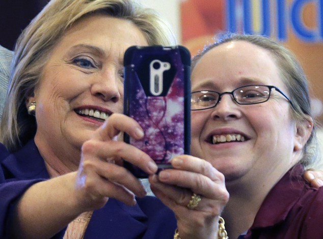 Democratic presidential candidate Hillary Clinton holds the phone to take a selfie with an employee at Market Basket Supermarket Tuesday Feb. 2 2016 in M