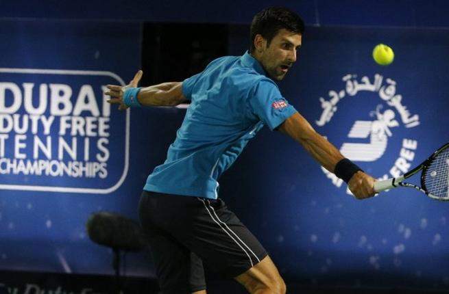 Novak Djokovic of Serbia returns the ball to Tunisian Malek Jaziri during their ATP tennis match on the third round of the Dubai Duty Free Tennis Championships