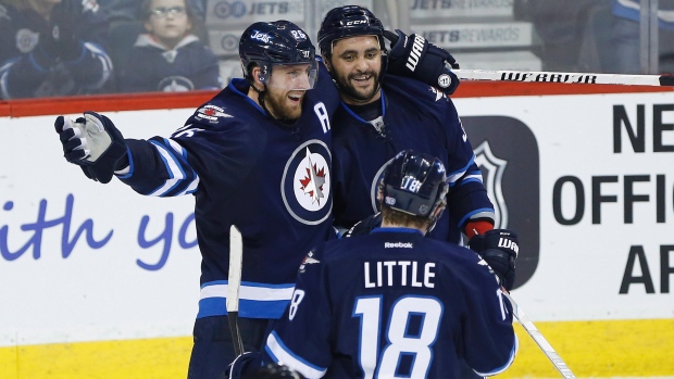 Blake Wheeler Dustin Byfuglien and Bryan Little celebrate Byfuglien's third-period goal