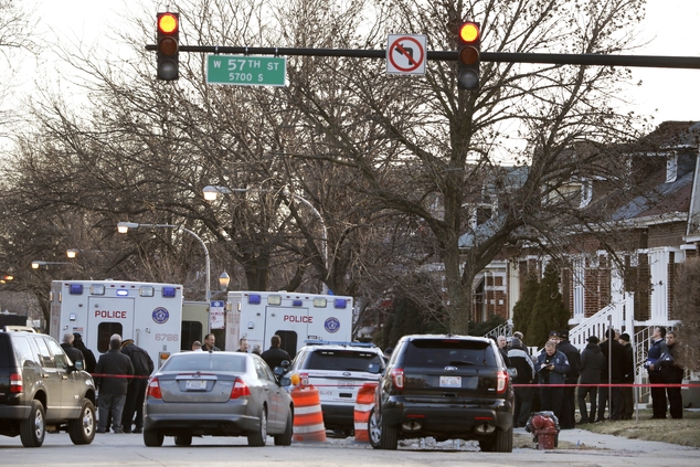 Chicago police work the scene outside a home where the bodies were found after police performed a well being check Thursday Feb. 4 2016 in Chicago. Interi