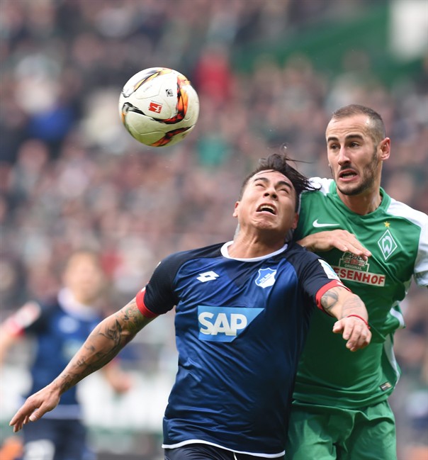 Hoffenheim's Eduardo Vargas, left challenges for the ball with Bremen's Alejandro Galvez during the German Bundesliga soccer match betweem Werder Bremen and TSG 1899 Hoffenheim in Bremen Germany Saturday Feb. 13 2016