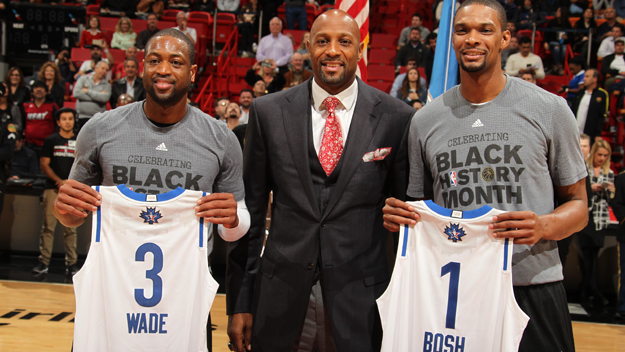 Former Miami Heat player Alonzo Mourning presents Dwyane Wade #3 of the Miami Heat and Chris Bosh #1 of the Miami Heat with their 2015-16 Eastern Conference All Star jerseys before the game against the San Antonio Spurs