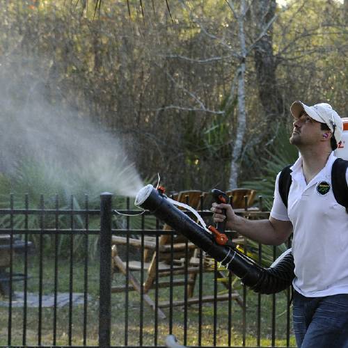 Darryl Nevins owner of a Mosquito Joe franchise sprays a backyard to control mosquitoes in Houston. Pest control companies in Texas are getting an early surge in business because of concerns that mosquitoe