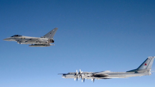 A British RAF Typhoon from Number XI Squadron RAF Coningsby in Lincolnshire shadows a Russian Bear-H bomber over the