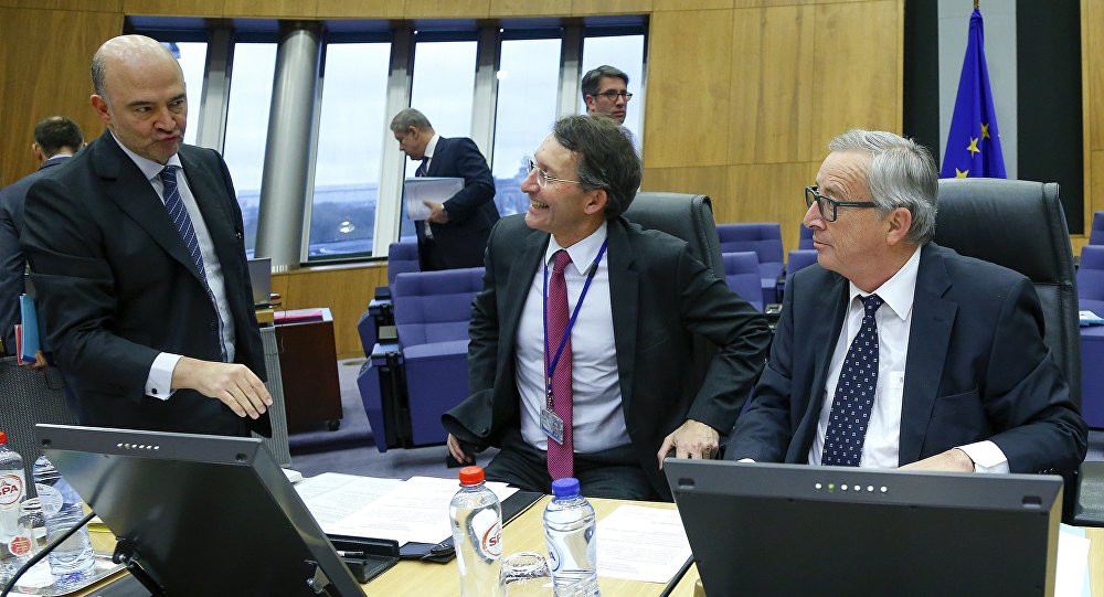 European Commission President Jean Claude Juncker talks with EU Economics Commissioner Pierre Moscovici during an extraordinary meeting with EU commissioners on the Portugal's budget in Brussels Belgium