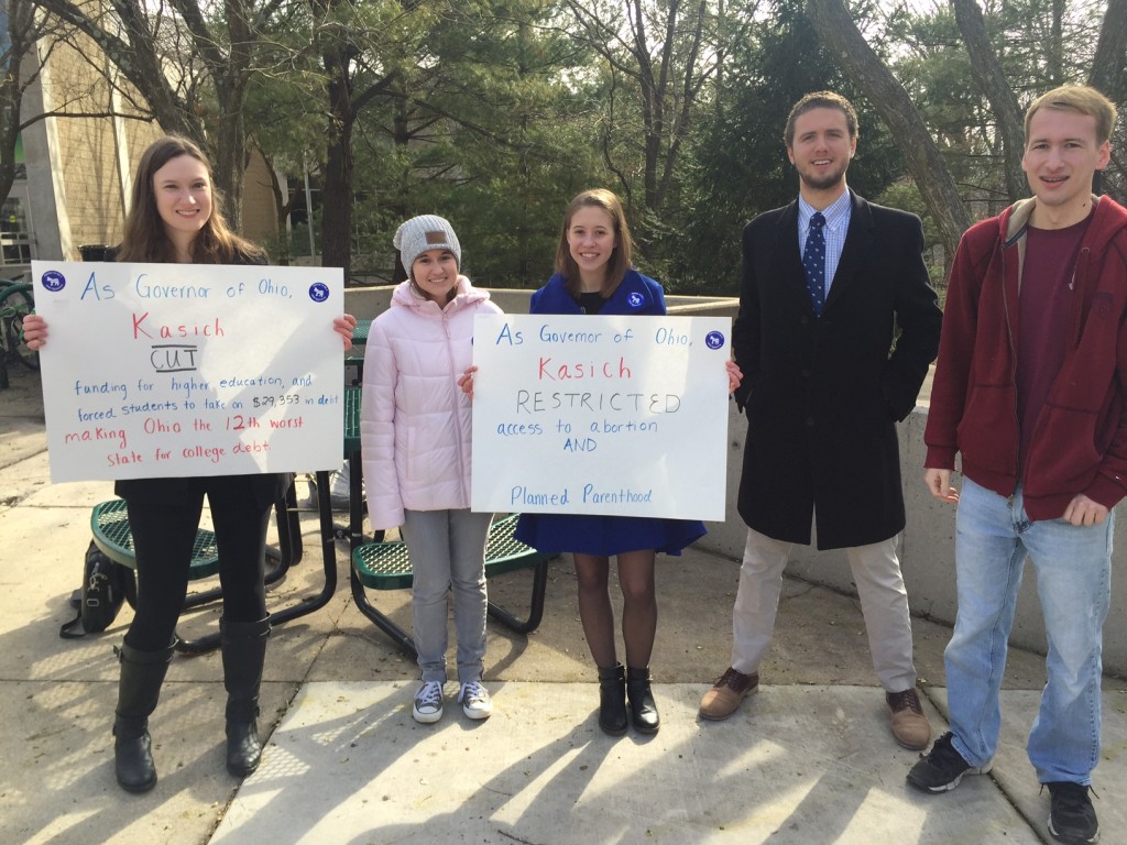 CREDIT Emily Atkin              Students with the GMU College Democrats protest John Kasich outside of his town hall event at the university on Monday