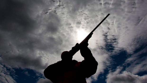 A rifle owner checks the sight of his rifle at a hunting camp property in rural Ontario west of Ottawa on Wednesday Sept. 15 2010. The Liberal government has broken a promise to immediately implement firearm-marking regulations to help police trace gun