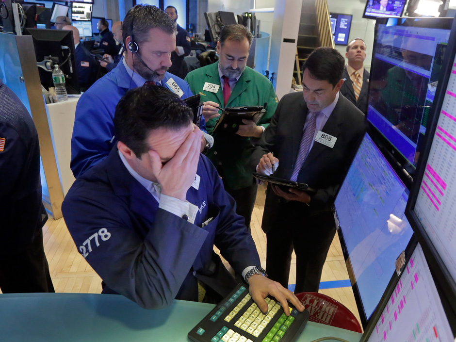 Specialist Michael Gagliano foreground works with traders at his post on the floor of the New York Stock Exchange Monday Feb. 1 2016. Another steep drop in oil and natural gas prices is pulling the stock market lower in early trading