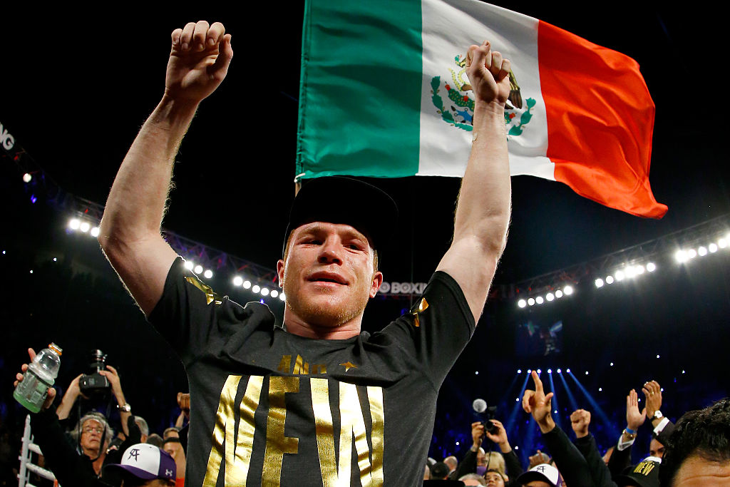 Miguel Cotto throws a right to the face of Canelo Alvarez during their middleweight fight at the Mandalay Bay Events Center