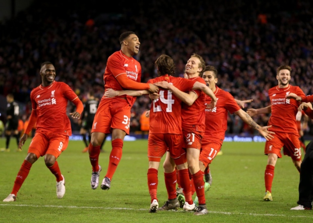 Liverpool's Joe Allen is mobbed by team-mates after scoring the winning goal in the penalty shootout during the Capital One Cup semi final second leg at Anfield