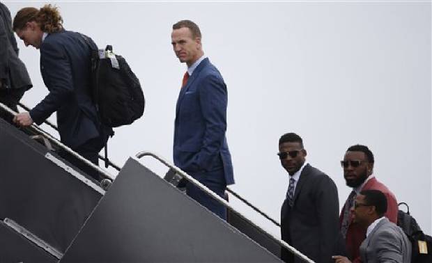 Denver Broncos quarterback Peyton Manning center joins teammates to board an airplane at Denver International Airport Sunday Jan. 31 2016. The Broncos are to face the Carolina Panthers on Sunday Feb. 7 in Super Bowl 50