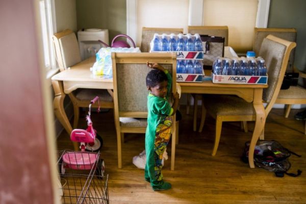 Cases of bottled water rest on the dining