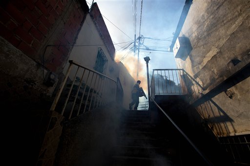 Fumigation A Sucre municipal worker fumigates for Aedes aegypti mosquitoes that transmit the Zika virus in the Petare neighborhood of Caracas Venezuela Monday Feb. 1 2016. Venezuela is reporting a jump in cases of a rare sometimes paralyzing syndrom