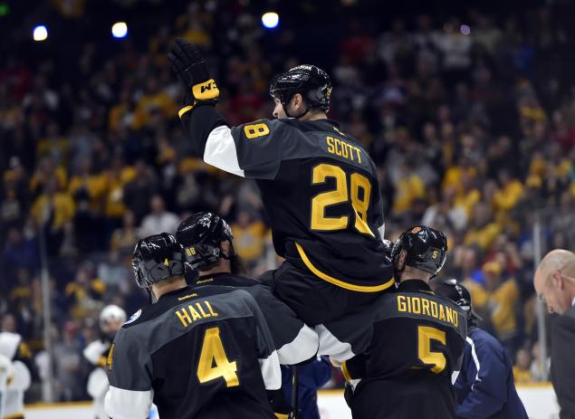 Scott's teammates carry him off the ice after he is named MVP