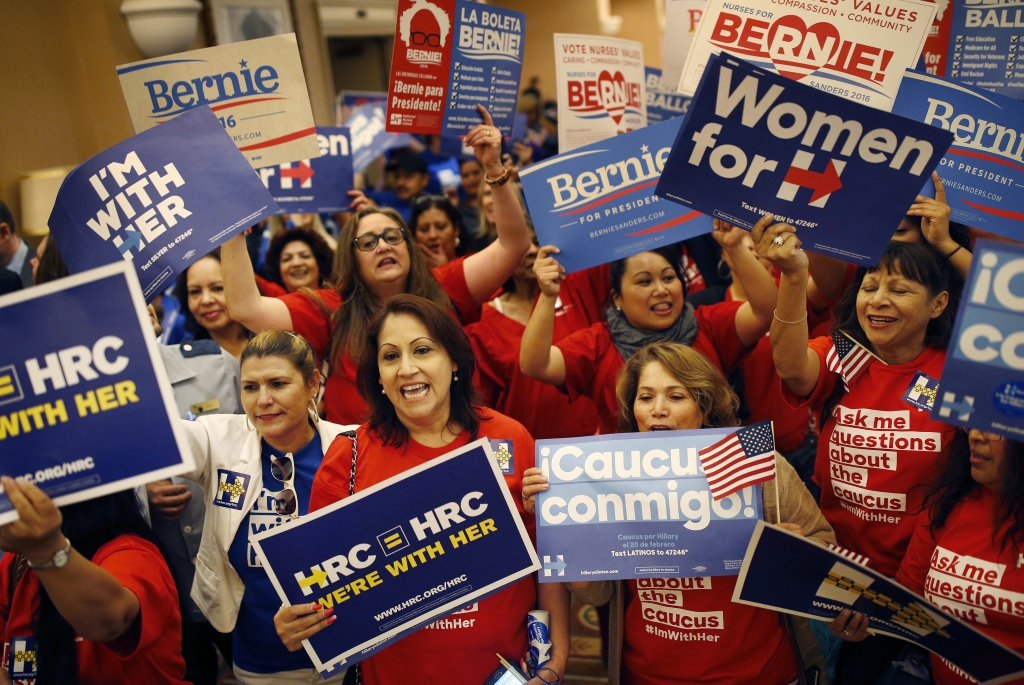 Supports of Hillary Clinton and Bernie Sanders cheer on their presidential candidates before entering a caucus site during the Nevada Democratic caucus Saturday Feb. 20 2016 in Las Vegas