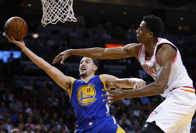 Golden State Warriors guard Klay Thompson attempts a shot against Miami Heat center Hassan Whiteside during the first half of an NBA basketball game Wed