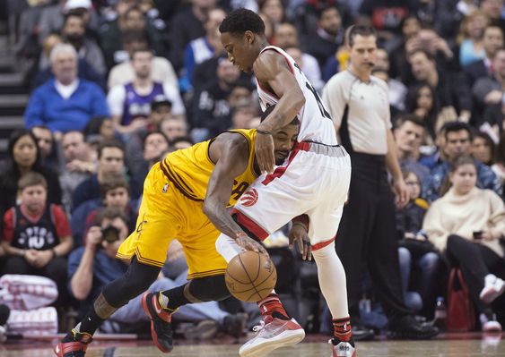 De Mar DeRozan blocks Cleveland Cavaliers guard Kyrie Irving during the first half of an NBA basketball game Friday Feb. 26 2016 in Toronto