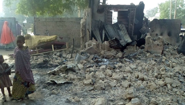 Children stand near the rubble of a burnt house after Boko Haram attacks at Dalori village on the outskirts of Maiduguri in northeastern Nigeria on Jan. 31 2016