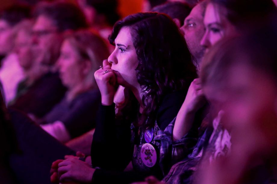 An audience member listens during a Democratic presidential primary debate between Democratic presidential candidate Sen. Bernie Sanders I-Vt and Democratic presidential candidate Hillary Clinton at the University of New Hampshire Thursday Feb. 4 2