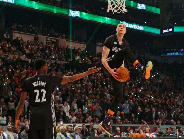 Minnesota Timberwolves Zach LaVine right takes the ball from teammate Andrew Wiggins as he competes during the NBA All Star Saturday Slam Dunk basketball contest Saturday Feb. 14 2015 in New York