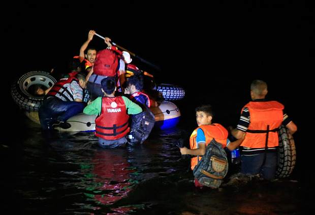 Migrants get into a boat to sail to the Greek island of Kos in Bodrum southwest Turkey